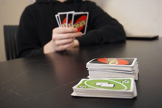 Ungdomar spelar kortspelet Uno